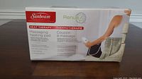 Photo of Sunbeam Massaging Heating Pad box showing product image and branding with partial description of features.