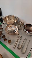 Entire lot: three bowls, seven tots, bottle opener, sugar tongs, angel candle holder