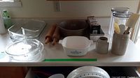 Wide view showing most items including casserole dishes, loaf pans, utensil holder, rolling pins, and containers.