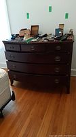 Front view of the dresser showing all six drawers and brass handles.