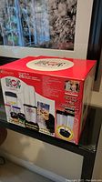 Photo of the front of the Magic Bullet Deluxe 26 piece set box showing branding and product image