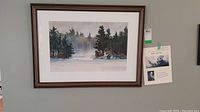 Overview of framed, matted watercolor hanging on wall