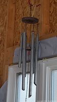 Metal wind chime hanging with five silver tubes and wooden parts