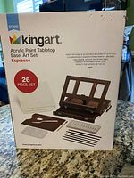 Box front showing product name, piece count, image of easel set with accessories