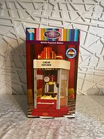 Front of box showing the nostalgic cinema style kettle popcorn maker with 'Cinema Popcorn' marquee.