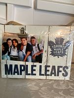 Front view of wooden photo board showing Toronto Maple Leafs text, logo and photo clip with sample photo.