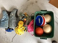 Photo showing two Avanti ski jackets, many ski ropes, and a green plastic bin filled with balls and frisbees