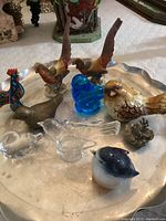 Photo showing all 10 bird figurines on metal tray, including two larger vintage Lefton Japan Golden Pheasant porcelain pieces and various glass and ceramic birds in different colors.