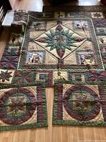 Full view of double size Christmas patchwork quilt with geometric and holiday motifs laid flat on floor with two matching pillow shams nearby.