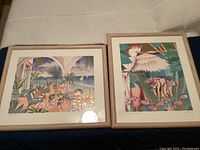 Two framed art prints by Kay Dawson titled 'Prime Time' (left) and 'Tropical Cockatiel' (right) laid side by side on fabric backdrop.