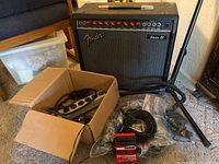 Overview of Fender amp, cables, pedal and stand