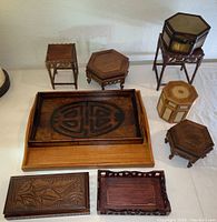 Photo showing full collection of various wooden trays and boxes on white surface.