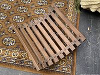 Wooden pagoda style blanket/wood log holder viewed at an angle showing the slats and construction details.