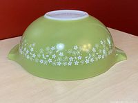 Bottom view of the vintage Pyrex bowl showing the underside with marking and the Spring Blossom Crazy Daisy pattern around the bottom edge.