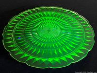 Top view of the green uranium glass cake plate showing diamond pattern and scalloped edges.