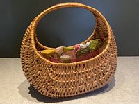 Front and side angled view showing the open woven wicker design and colorful liner inside.