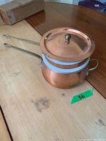 Photo showing the full assembled copper and ceramic double boiler pot with lid on top.