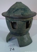 Side view of the lantern showing the shape, texture and three legs.
