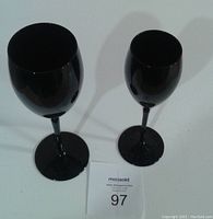 Photo of two black crystal wine goblets showing different sizes and shape from front