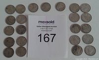 Coins arranged with maxsold lot number card in the center and the dimes placed in multiple rows.