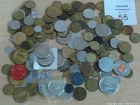 Photo showing a large mixed collection of approximately 147 tokens and medals various sizes and colors laid out on a surface.
