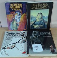 Four books by Gary Larson from The Far Side series on a wooden surface showing their front covers.