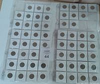 Plastic binder sheets holding 59 United States quarters dated 1965-1997 in individual 2x2 holders, arranged for display and sale.