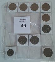 Photo of 10 US coins from 1971 to 1979 in 2x2 holders, including Philadelphia and Denver mint marks, arranged in a plastic coin holder page.
