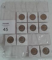 Photo showing 10 United States half dollars from 1971 to 1980 in 2x2 holders within a plastic sleeve.