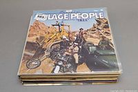 Stack of vinyl records with Village People 'Y.M.C.A.' album on top