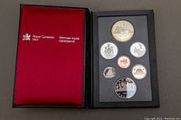 Front image showing the full collectible coin set in original Royal Canadian Mint case with red lining and black exterior case.
