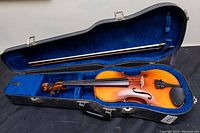 Open case showing violin and bow inside