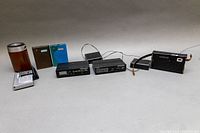 Overall view of six vintage battery-powered radios of various brands and formats