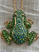 Front view showing the frog pendant covered with green, blue-green and black faceted rhinestones set in gold tone metal.