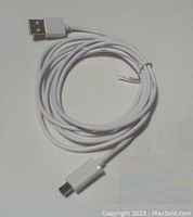 Single white USB charging cable coiled, showing USB-A and micro-USB connectors.