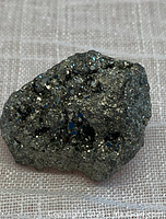 Front angle view of natural pyrite crystal cluster showing metallic luster and crystal facets.