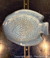 Top view showing fish shape, embossed scales and fins, blue glaze with detailed texture.