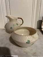 Set of a creamer and sugar bowl showing the textured basket weave detail and shamrock pattern