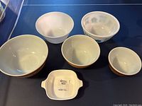Overhead view of the three Pyrex mixing bowls and CorningWare dish showing sizes and patterns