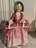 Front view of Royal Doulton Bo-Peep porcelain figurine in pink dress holding shepherd's crook.