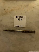 Top view of the pencil showing the full length with clip, showing tarnish and mechanical lead extended