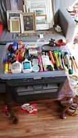 Brother DCP 7060D printer with various office supplies on top, including pens, glue, and staplers.