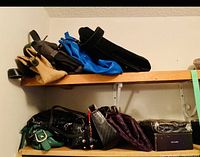 Photo showing two shelves full of different women's purses in various colors and materials including leather and man-made.