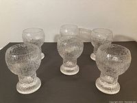 Six goblets arranged in two rows on black background