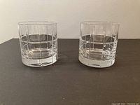 Front view of the pair of Orrefors double old fashioned glasses showing the geometric cut pattern etched into the glass.