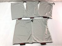 Five new light gray microfiber fabric pouches laid out in two rows, showing size and quantity.