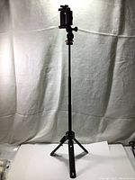 Full view of Joby Grip Tight Pro TelePod tripod fully extended with phone mount attached. Fiberglass reinforced foldable legs in tripod position.