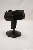 Side view of black Thronmax MDrill Zero Plus USB microphone on a round base stand showing its compact form and build.