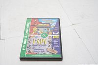 Front cover of the DVD case showing the product title and colorful graphics of Clifford The Big Red Dog and I Spy Spooky Mansion for PC and Mac learning.