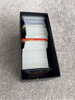 Top view inside the Pokémon Elite Trainer Box showing multiple stacks of Pokémon cards.